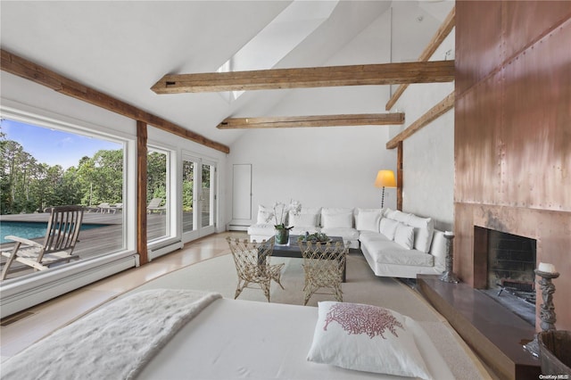 tiled living room featuring beam ceiling, a baseboard radiator, and high vaulted ceiling