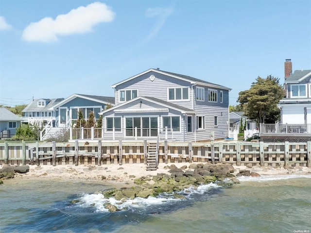 4235 Camp Mineola Rd, Mattituck, NY 11952 - rear view of property featuring a water view, stairs, and a sunroom