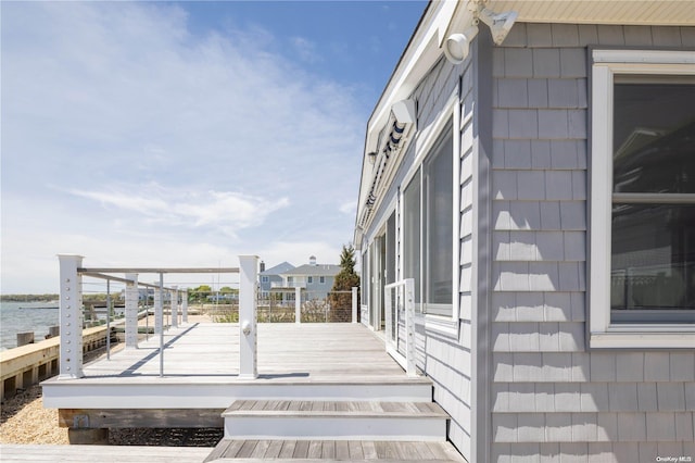 wooden deck featuring a water view