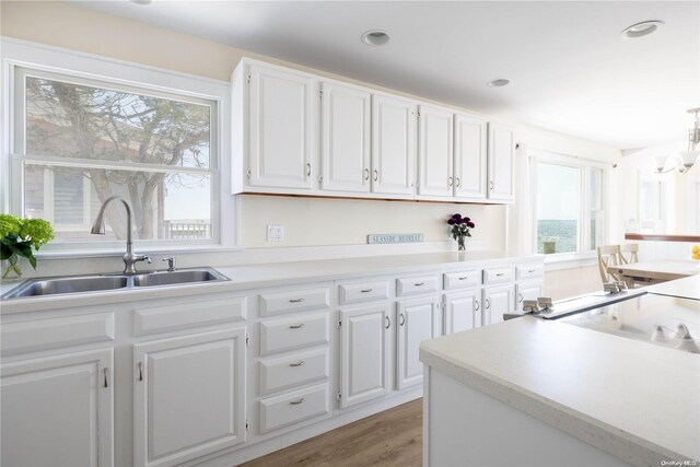 4235 Camp Mineola Rd, Mattituck, NY 11952 - kitchen featuring a sink, white cabinetry, light countertops, light wood-style flooring, and recessed lighting