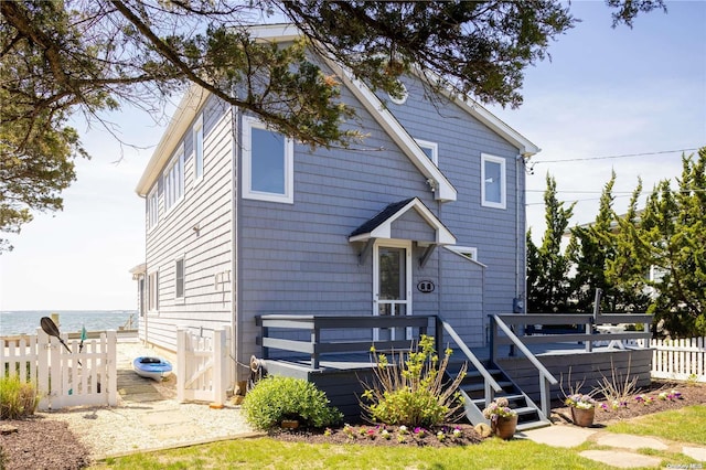 view of front of house with a deck with water view