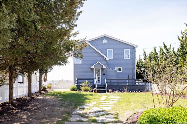 rear view of property with a lawn