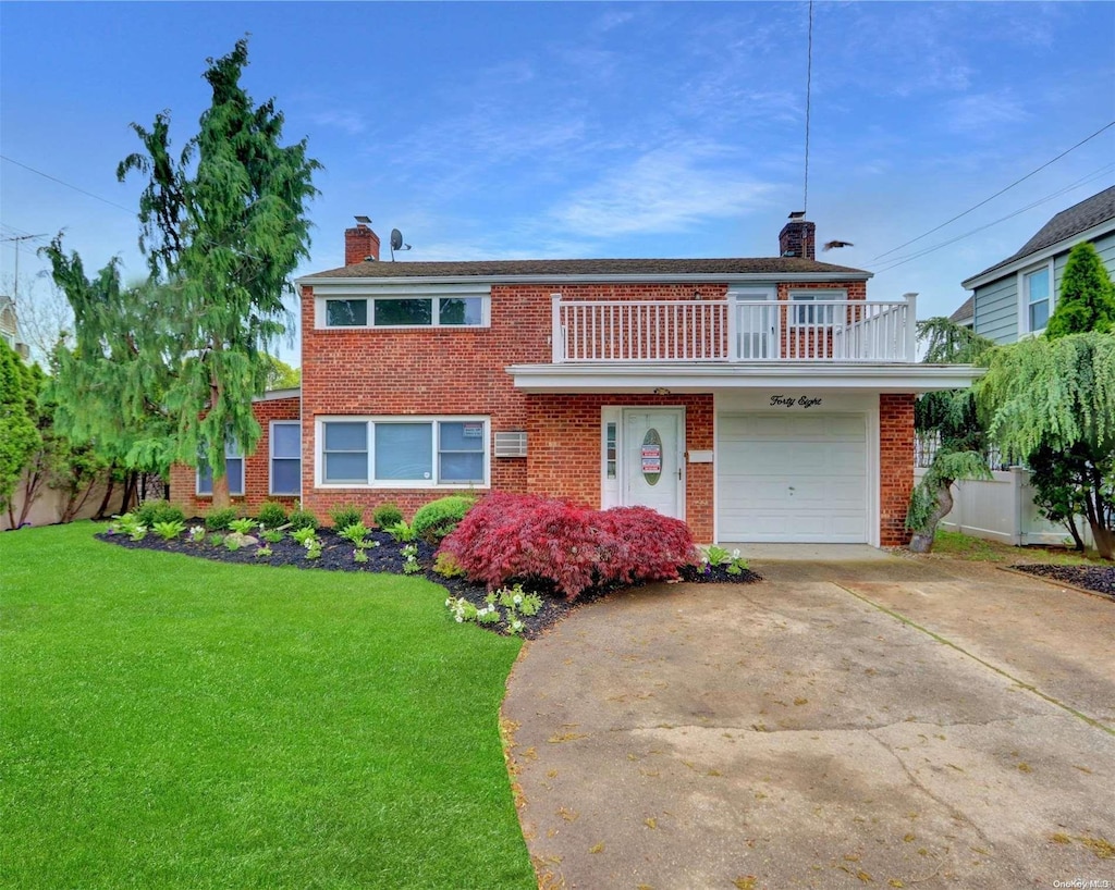 view of front of house with a balcony, a garage, and a front lawn