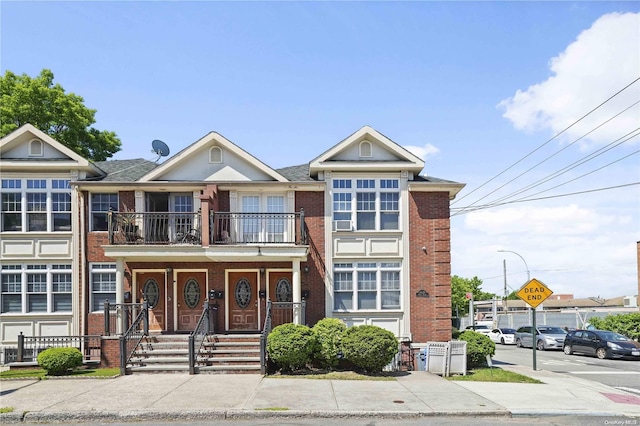 townhome / multi-family property featuring a balcony and a porch