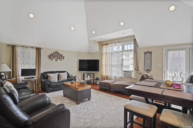 living room featuring a high ceiling, hardwood / wood-style flooring, and cooling unit