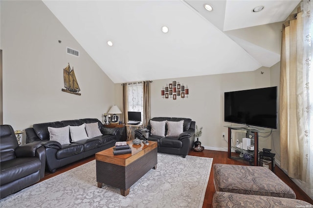 living room with wood-type flooring and high vaulted ceiling