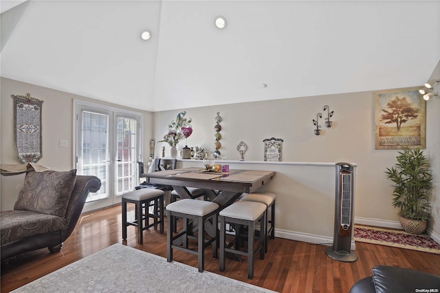 dining space with dark hardwood / wood-style flooring and lofted ceiling