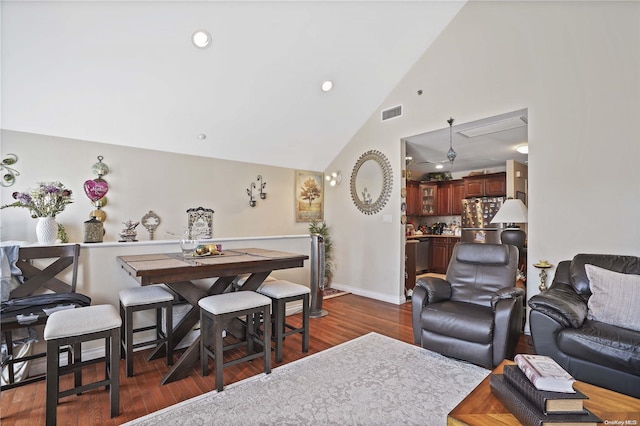 living room with dark hardwood / wood-style flooring, high vaulted ceiling, and ceiling fan