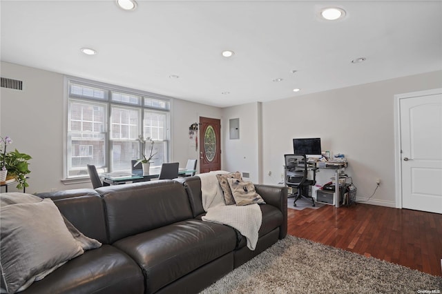 living room with electric panel and dark wood-type flooring