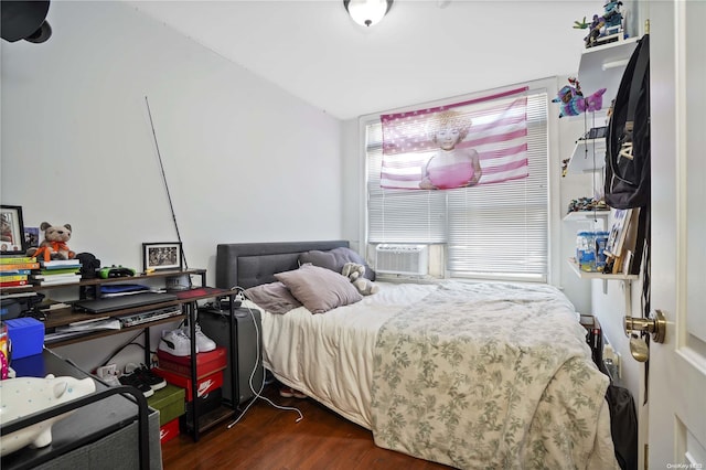 bedroom featuring cooling unit and dark wood-type flooring