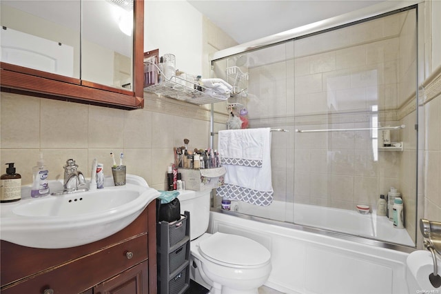 full bathroom with backsplash, vanity, tile walls, enclosed tub / shower combo, and toilet