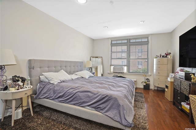 bedroom with cooling unit and dark hardwood / wood-style floors