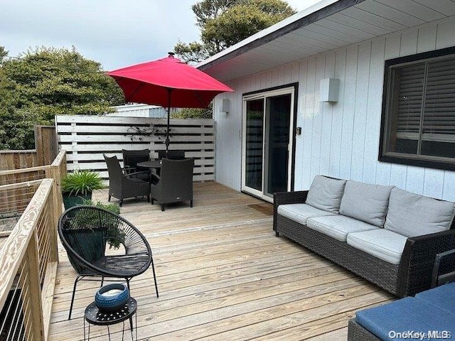 wooden terrace featuring outdoor lounge area