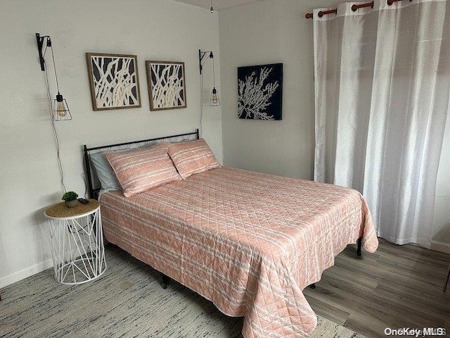 bedroom with wood-type flooring