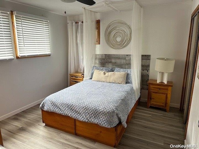 bedroom with hardwood / wood-style floors and ceiling fan