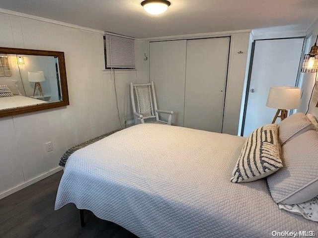 bedroom with a closet and dark hardwood / wood-style flooring