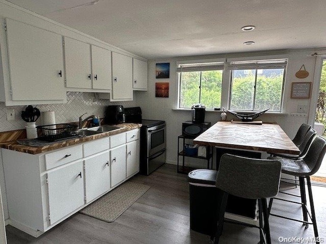 kitchen featuring light hardwood / wood-style floors, white cabinetry, sink, and black range with electric cooktop