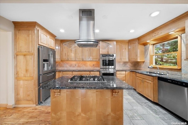 kitchen featuring a center island, sink, stainless steel appliances, dark stone counters, and island range hood