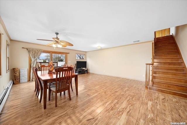 dining area with ceiling fan, light hardwood / wood-style flooring, a baseboard heating unit, and ornamental molding