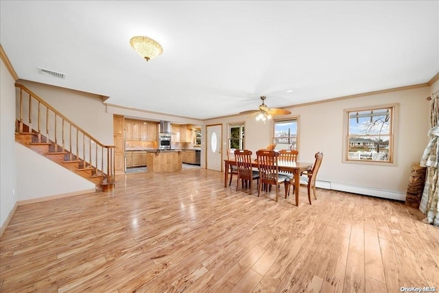 dining room featuring ceiling fan, ornamental molding, light hardwood / wood-style floors, and a baseboard heating unit