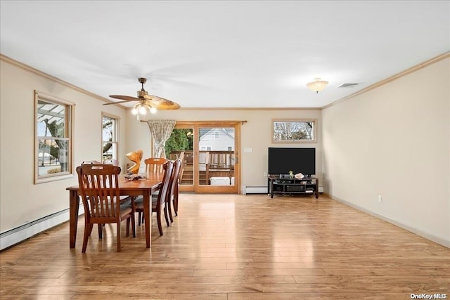 dining space with ceiling fan, crown molding, a baseboard radiator, and light wood-type flooring