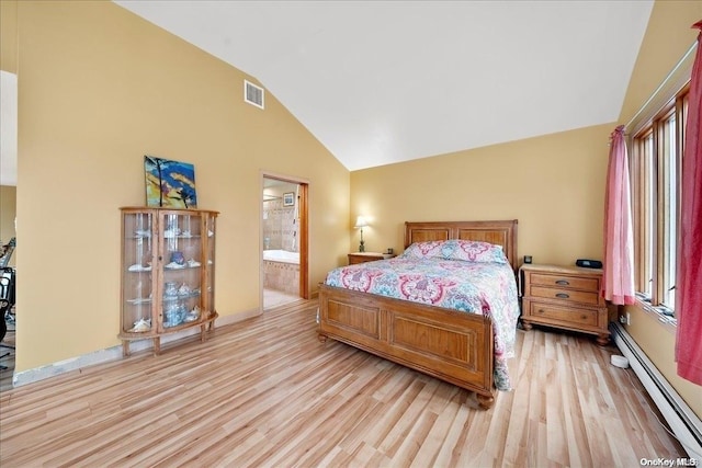 bedroom featuring lofted ceiling, baseboard heating, connected bathroom, and light hardwood / wood-style flooring