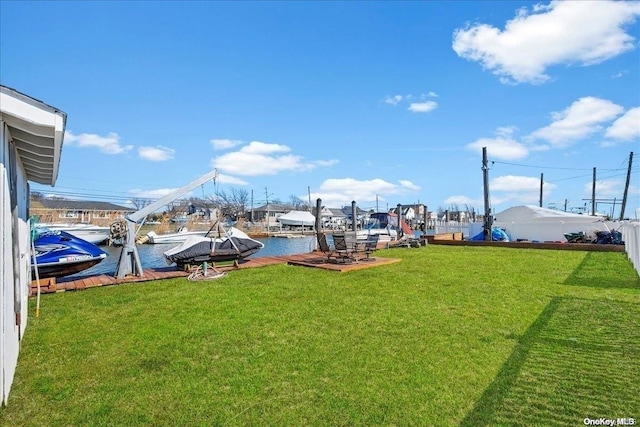 view of yard featuring a water view and a dock