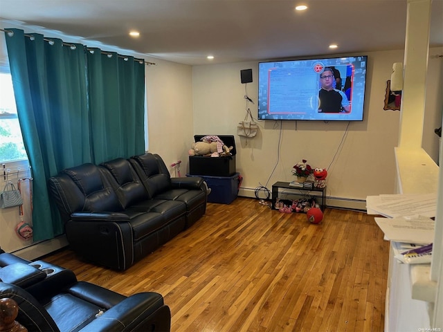 living room featuring baseboard heating and wood-type flooring