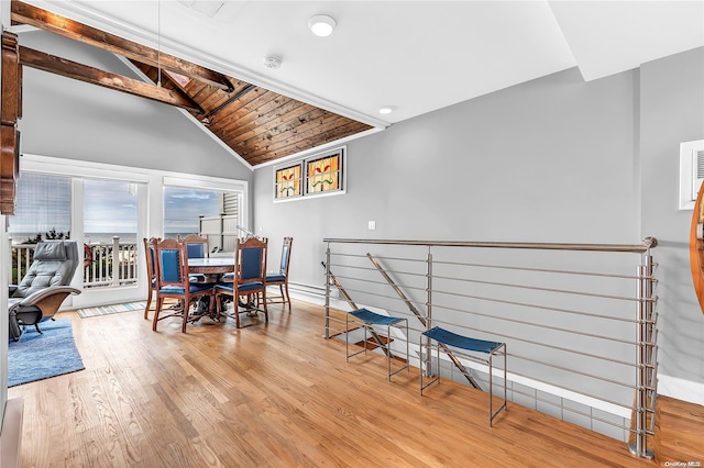 dining room with lofted ceiling with beams, light hardwood / wood-style floors, and wood ceiling