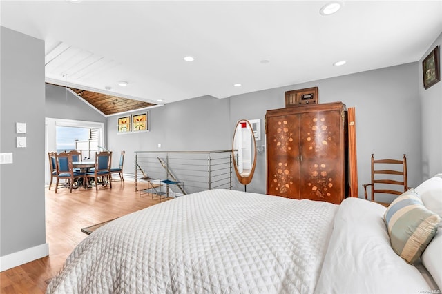 bedroom with wood ceiling, light hardwood / wood-style flooring, and vaulted ceiling