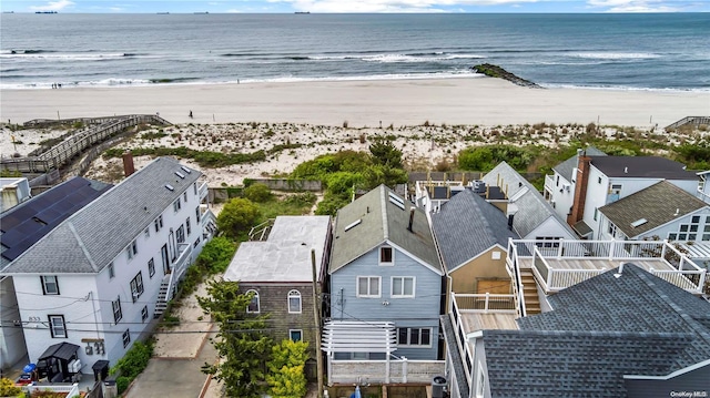 drone / aerial view featuring a beach view and a water view