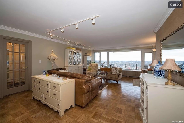 living room with parquet floors, track lighting, and ornamental molding