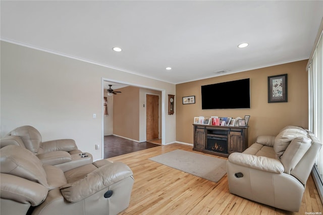 living room featuring wood-type flooring and crown molding