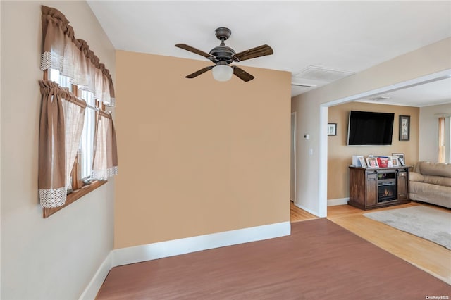 unfurnished living room featuring ceiling fan and light hardwood / wood-style floors