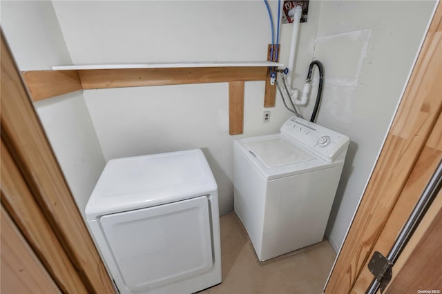 clothes washing area with separate washer and dryer