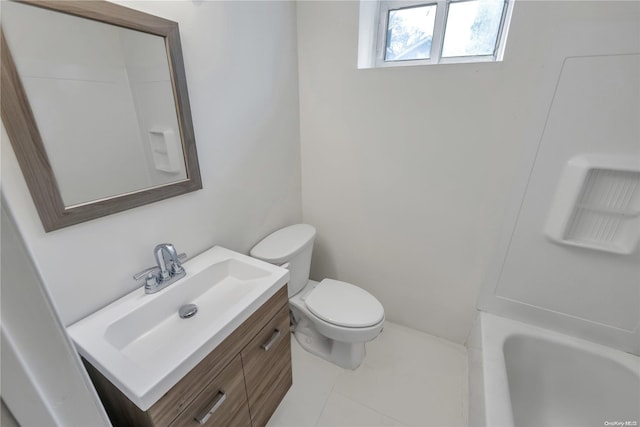 bathroom with tile patterned floors, vanity, toilet, and a bathtub