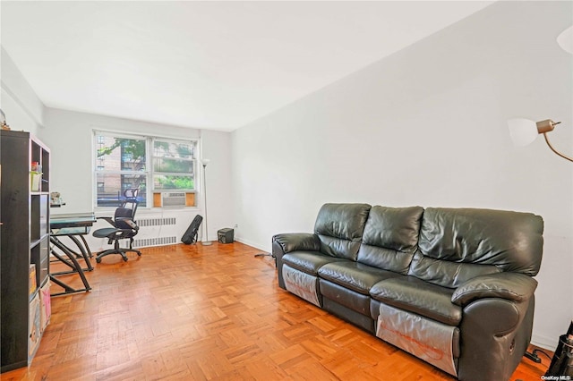 living room with light parquet flooring, radiator, and cooling unit