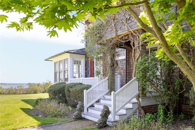 doorway to property with a yard