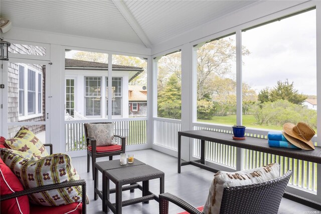 sunroom featuring lofted ceiling and a wealth of natural light