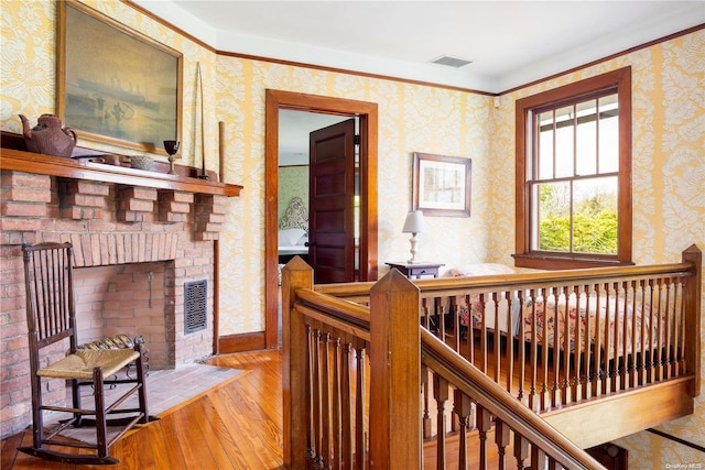 hall featuring hardwood / wood-style floors and ornamental molding