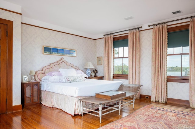 bedroom featuring hardwood / wood-style flooring and multiple windows