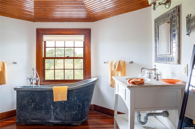 bathroom featuring wooden ceiling, wood-type flooring, a tub, vaulted ceiling, and sink