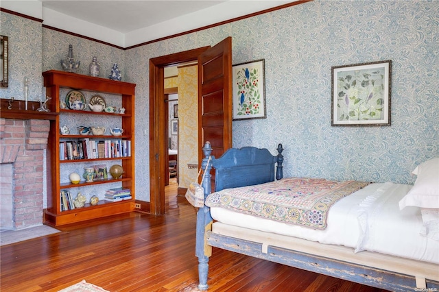 bedroom featuring dark wood-type flooring and a brick fireplace