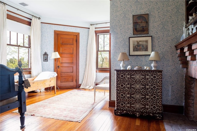 interior space with hardwood / wood-style flooring and multiple windows