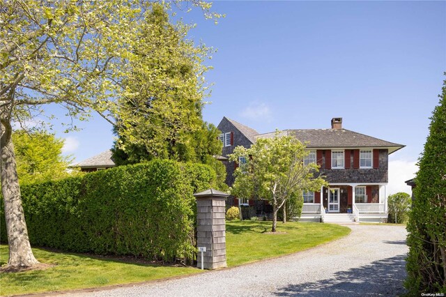 colonial home with a front lawn