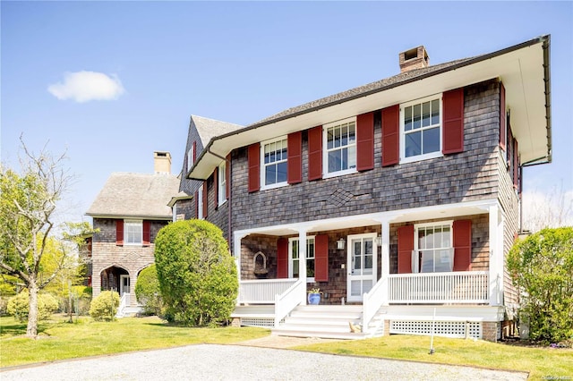 view of front of house with a front yard and a porch