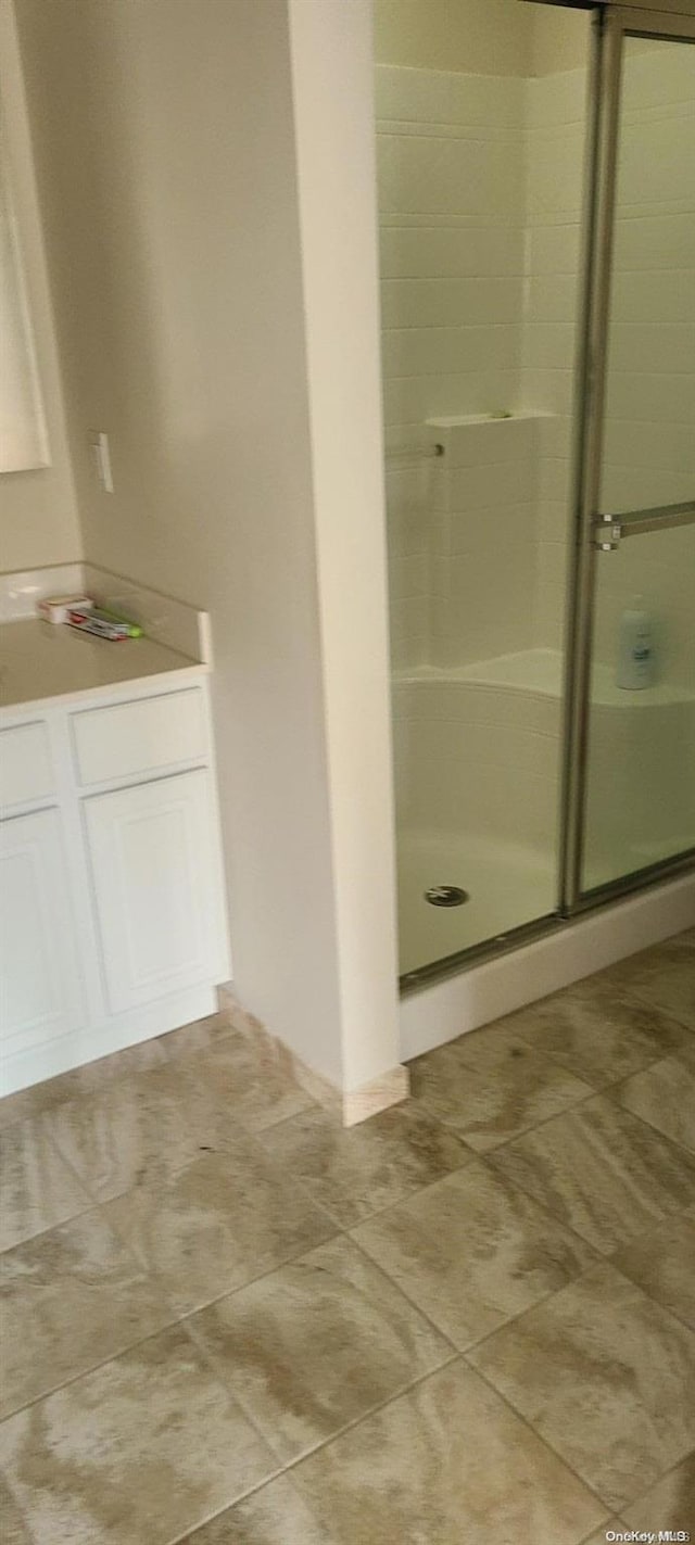 bathroom with a shower with shower door