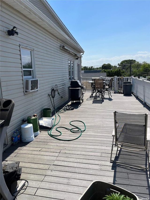 wooden terrace featuring area for grilling