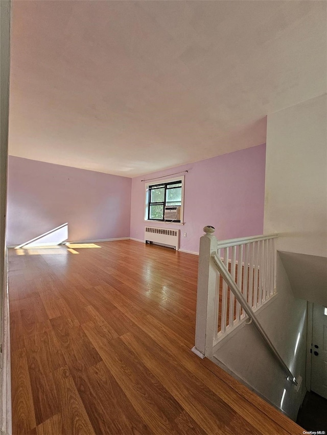 empty room featuring hardwood / wood-style floors and radiator