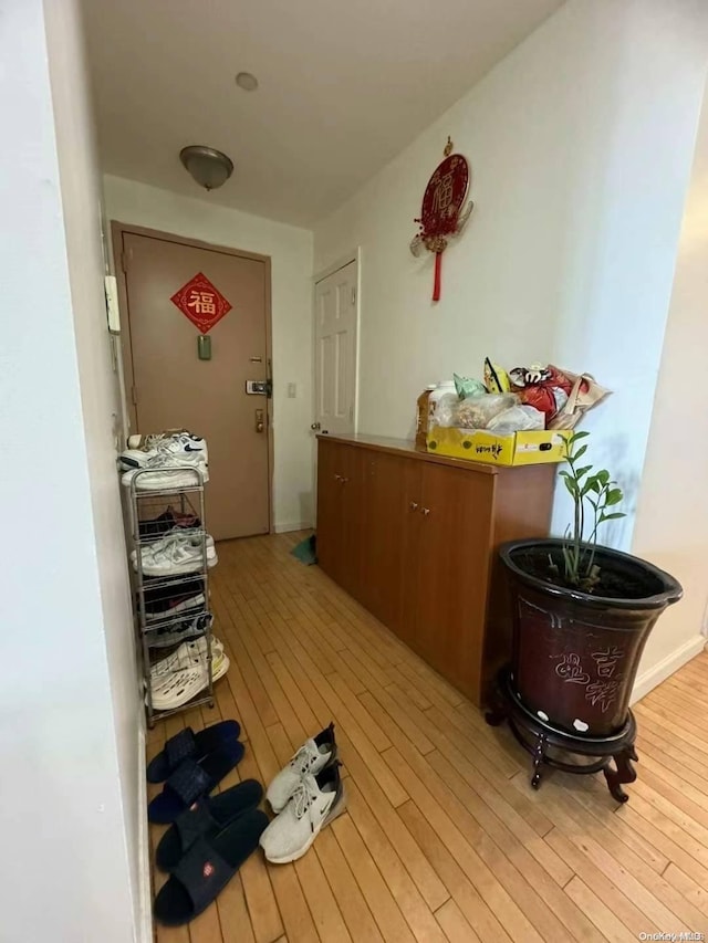 hallway with light hardwood / wood-style flooring